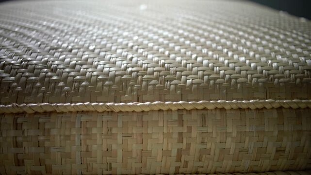 Close-up view of intricately woven natural fiber texture showcasing a soft, neutral color palette with subtle lighting