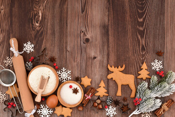 Festive Christmas background. Gingerbread baking preparation on a rustic wooden table during the holiday season
