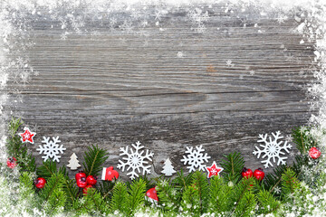 Christmas decorations and spruce branches on a wooden table. Festive  background. Top view, copy space.