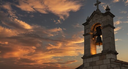 historic stone church bell tower silhouetted against vibrant sunset sky with dramatic clouds