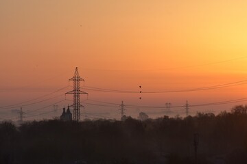 Sunrise over the city in the early morning. Winter fogy landscape