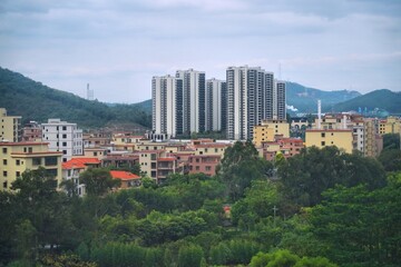 City residential architecture and green hills of Qingcheng District in Qingyuan, Guangdong region of China.