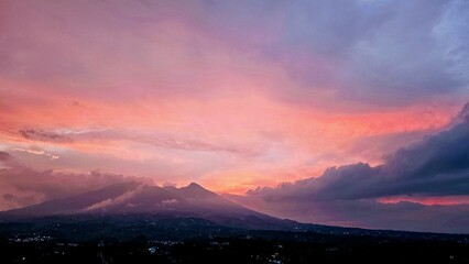 A scenic view of colorful sunset sky. Sunset in the mountains. serene Vibrant Sunset Over Silhouetted Mountains

