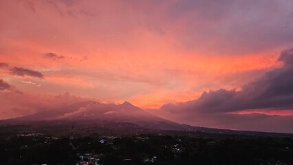 A scenic view of colorful sunset sky. Sunset in the mountains. serene Vibrant Sunset Over Silhouetted Mountains
