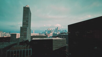 timelapse skyline with iconic tower drone approach capturing motion blur, streaking clouds, emerging city lights, traffic trails, dynamic urban energy,