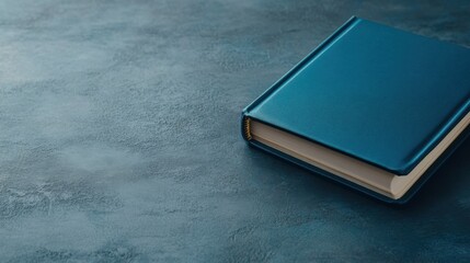 Elegant Blue Book on a Textured Surface for Academic and Creative Use