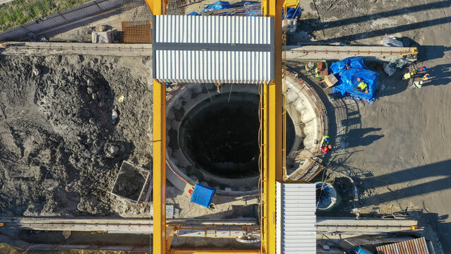 Aerial view of a construction site with a deep circular excavation pit and heavy lifting equipment in Avcılar, Istanbul, Istanbul, Turkey.