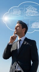 A well-dressed man ponders architectural home designs within a cloud against a clear blue sky. He seems deep in thought