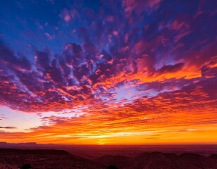 ibrant sunset sky with streaks of orange pink and purple clouds painting the horizon in a b.jpg