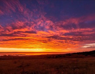 ibrant sunset sky with streaks of orange pink and purple clouds painting the horizon in a b.jpg