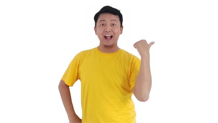 amazed and smiling happy Asian man pointing finger at copy space on left side or right side. Indonesian man pointing finger at advertisement.