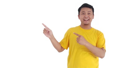 amazed and smiling happy Asian man pointing finger at copy space on left side or right side. Indonesian man pointing finger at advertisement.