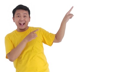amazed and smiling happy Asian man pointing finger at copy space on left side or right side. Indonesian man pointing finger at advertisement.