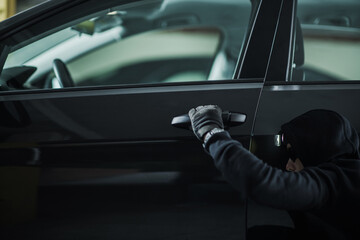 Person Attempting to Steal From a Car in a Parking Area at Night