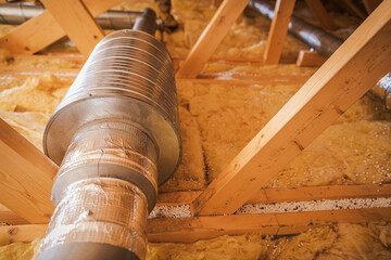 Copper Pipe and Duct Work in Attic Space With Insulation and Wooden Beams