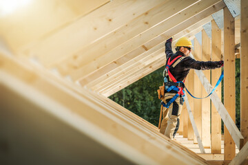 Worker on Roof Frame in Construction Site During Sunny Day in the Afternoon