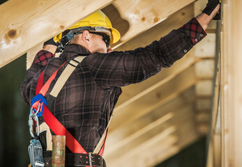 Worker Builds Structure Using Tools and Safety Gear During Construction Work