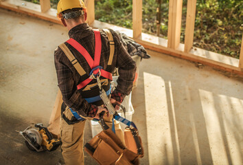 Worker Prepares for Construction Task in Wooden Building During Daytime