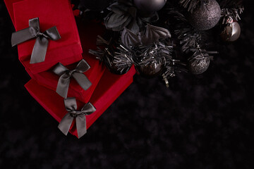 Gothic Christmas Elegance. A stylish contrast of black ornaments and red gifts