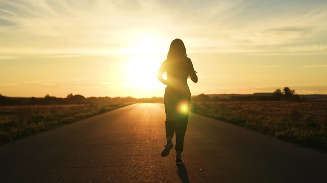 silhouette sports girl running legs along road sunset, energetic female runner training competition, athlete cardio training, mindful running, triathlete running, man running with effort, endurance