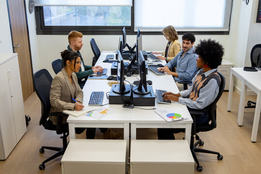 Diverse business team collaborating in modern office workplace - Powered by Adobe