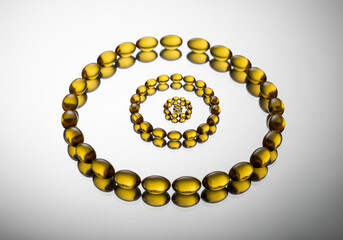 Abstract composition of golden liquid droplets arranged in concentric circles on a reflective surface