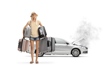 Female tourist with car problem holding many suitcases