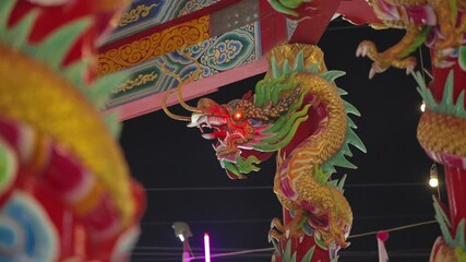 SARABURI, THAILAND - DECEMBER 21, 2025: Traditional red lanterns and dragon decorations at a Chinese temple festival ahead of Chinese New Year 2026.