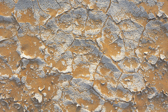 View of cracked earth revealing parched land beneath a layer of dried sediment in the arid expanse, Bateen Liwa, Abu Dhabi, United Arab Emirates.