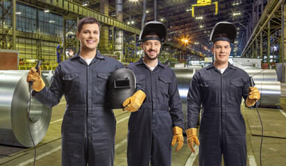 Workers in uniforms with welding machines