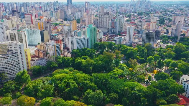 Curitiba cinematic aerial drone view showcasing the urban architecture, avenues, and vibrant downtown city center of Curitiba, Paran&aacute;, Brazil, highlighting the modern skyline, dense metropolitan view.