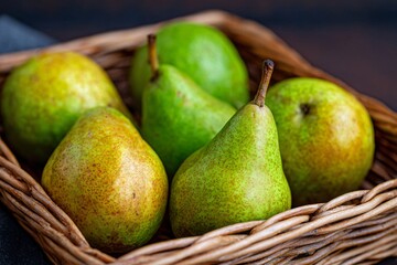 A close-up display of fresh pears nestled in a woven basket. The pears exhibit mottled green and yellow skin, showing variations in color and texture. The wooden background adds warmth to the scene