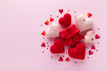 Red gift box decorated with various love hearts on pink background. Valentine Day or Mother Day greeting card template.