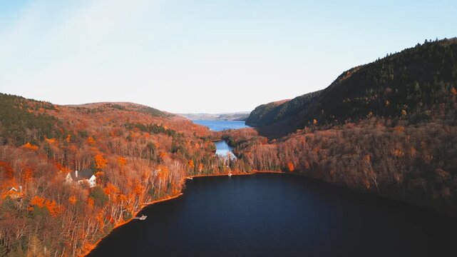 Lac-du-Sable, Canada - Oct.19 2025: The colourful autumn foliage 4k drone aerial view of Lac-du Sable in Quebec Canda