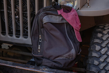 Travel backpack and cap preparing for an off road adventure