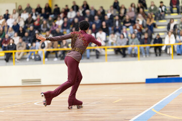 Roller skater performing artistic routine at indoor competition