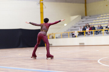 Skater performing acrobatic balance during artistic roller skate competition