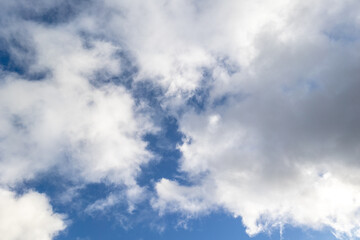 Soft clouds captured against a bright blue sky, offering a clean and peaceful sky background ideal for nature, weather, or relaxation concepts.