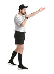 Referee in uniform blowing whistle on white background