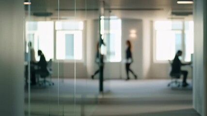 Blurred view of professionals walking in a modern office space with glass partitions. Represents a dynamic work environment and collaboration in corporate settings - Powered by Adobe