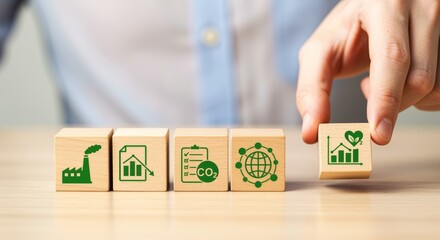 Hand arranging wooden blocks with sustainability icons