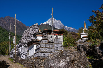 A big mani wall and mani stone, with endraved and painted mantra "om mani padme hum" near Phakding village. Everest base camp trek, Nepal.
