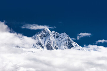 Mt. Lhotse viewed from the viewpoint above Namche bazaar. Snowy mount over the clouds against blue sky. Acclimatization day in Namche on Everest base camp trek, Nepal.