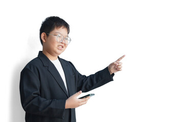 A young businessman in a suit holds a smartphone in his right hand and points to an empty space with his left hand, against a white background.