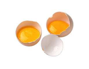 Close-up view of three parts of a cracked egg, revealing bright yellow yolks against a black background