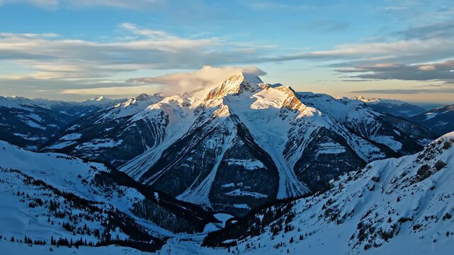 Snowy mountain peak with forested slopes