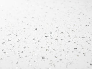 Closeup view of small water droplets on a white surface with tiny bubbles