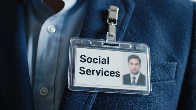 Witness the commitment of a social services worker as they navigate their responsibilities, wearing an identification badge that symbolizes their role in helping others.