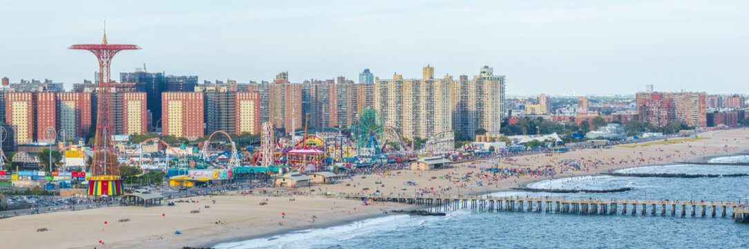 Aerial view of the vibrant Coney Island skyline, where the iconic parachute jump meets the bustling beach and boardwalk, Brooklyn, New York, United States.