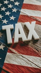 Letters spelling out tax on a vintage wooden table with an American flag in the background during a quiet morning